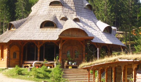 Blockbohlenbau mit Holz-Schindeldeckung
Vor allem im Bereich des Tourismus findet man häufig konsequent ökologisch errichtete Gebäude. Eine Herberge in Blockbauweise mit Holzschindeldach wirkt besonders einladend.